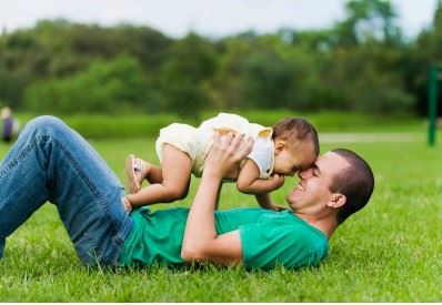 parent and child on a lawn